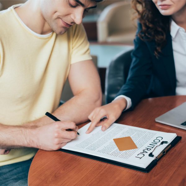 selective-focus-of-happy-man-signing-contract-near-2023-11-27-05-15-30-utc (1)